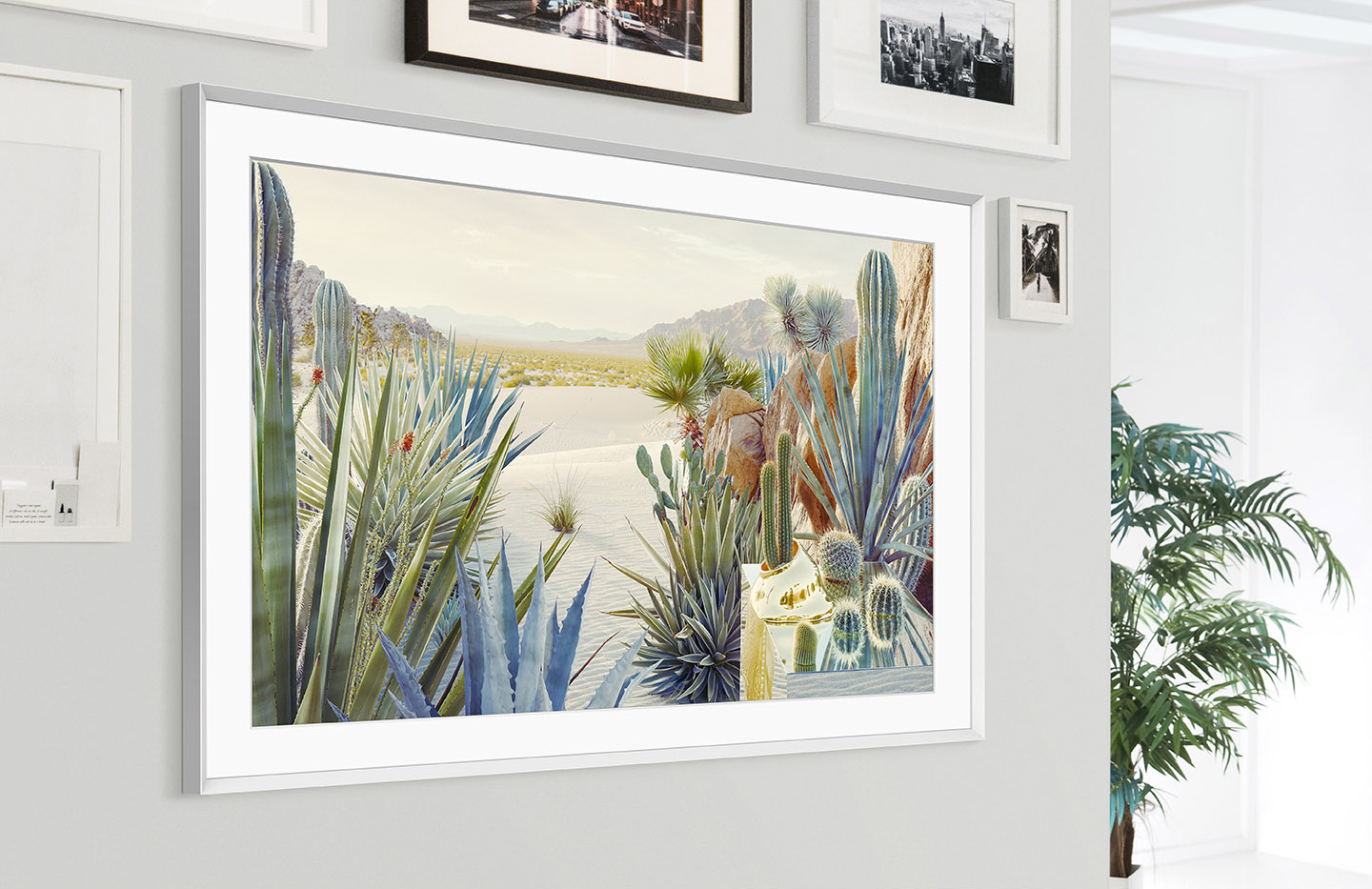 The Frame is mounted on the wall of a home interior and its modern frame design blends with the other picture frameson the wall.